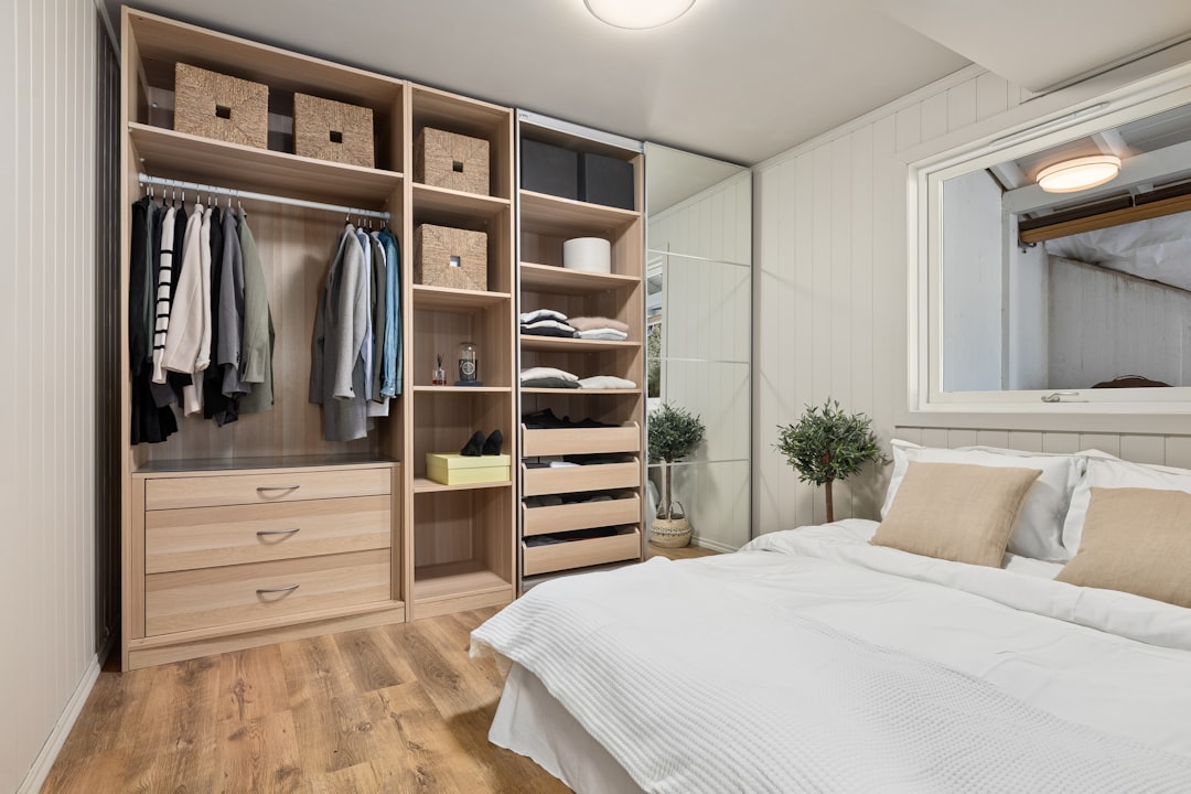 Modern bedroom closet with natural wood tones and organized storage compartments