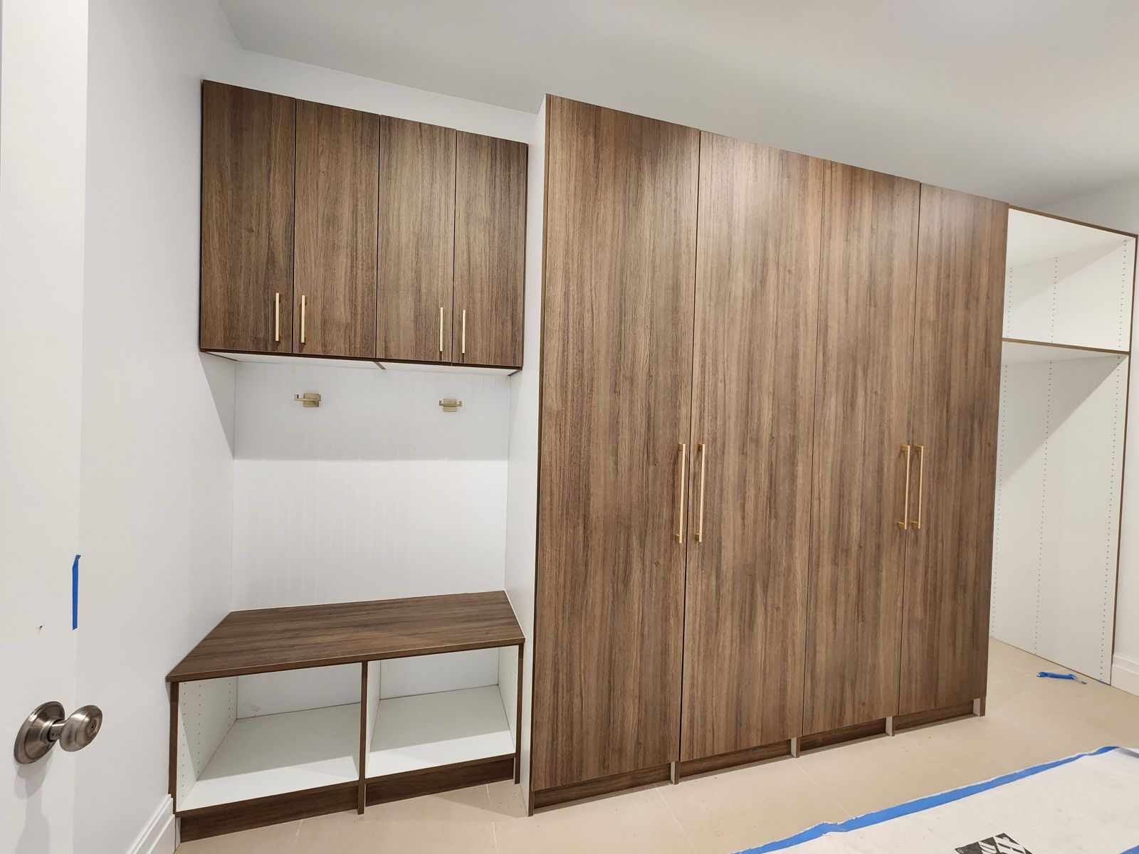 Professional garage storage system featuring wood finish cabinets and organized tool storage for comprehensive garage organization