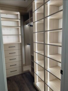 Luxury closet detail showing premium finishes and elegant white storage solutions