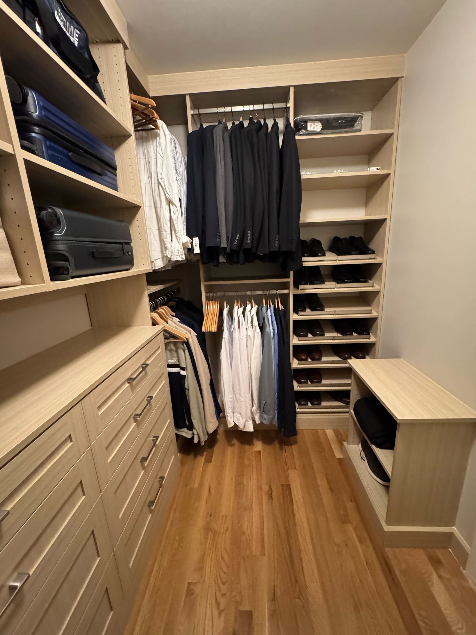 Men's walk-in closet with suit organization, dress shirt storage, and formal wear display