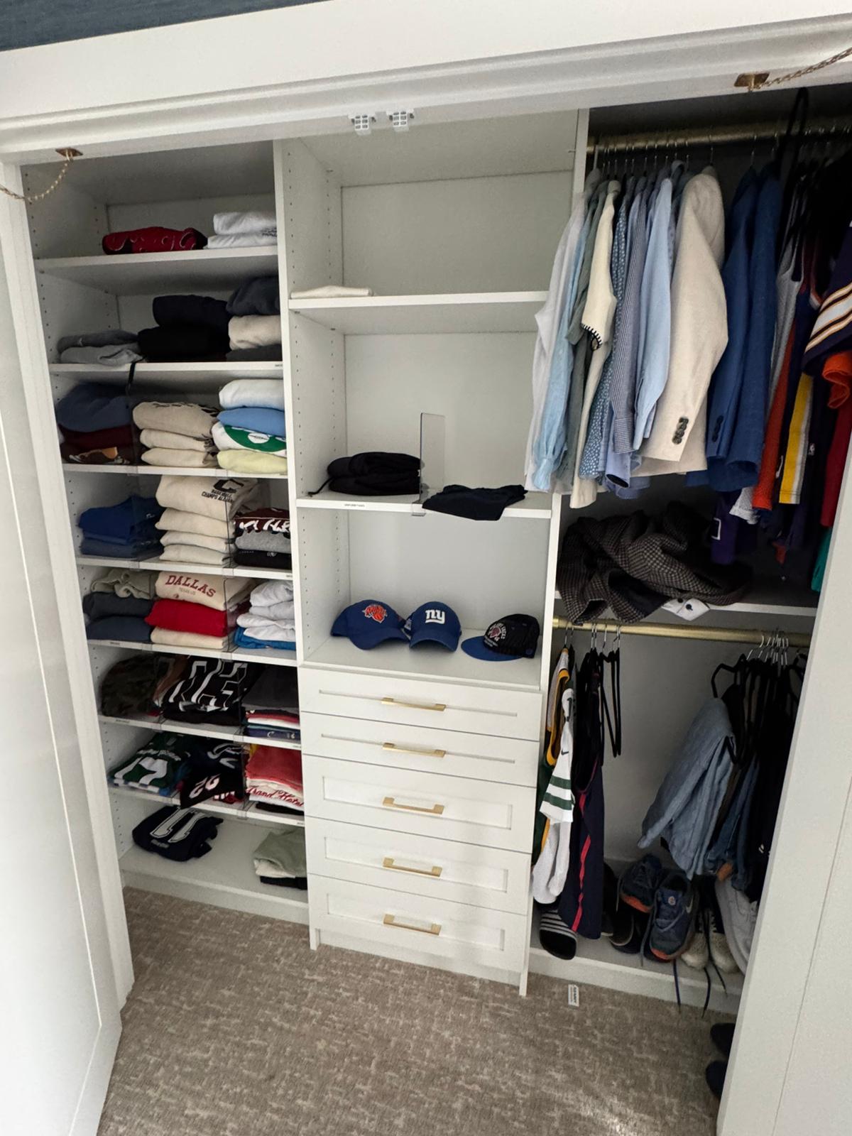 Reach-in closet featuring sports memorabilia display with organized storage systems
