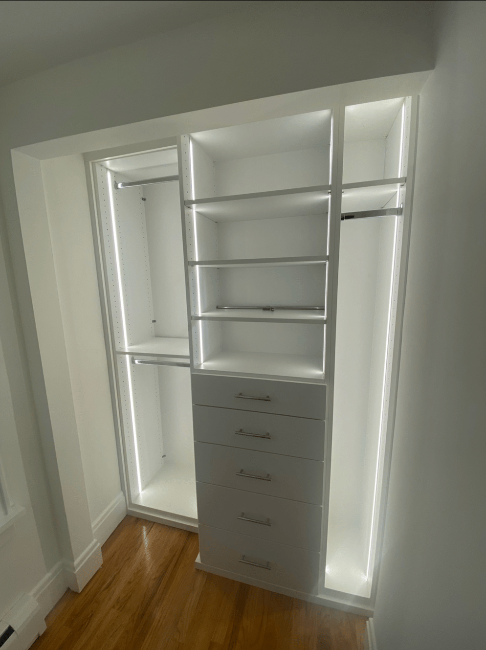 Small reach-in closet with white storage system and efficient organization for compact spaces
