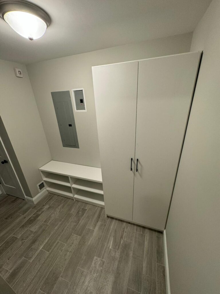 Walk-in pantry with comprehensive white shelving and organized food storage systems
