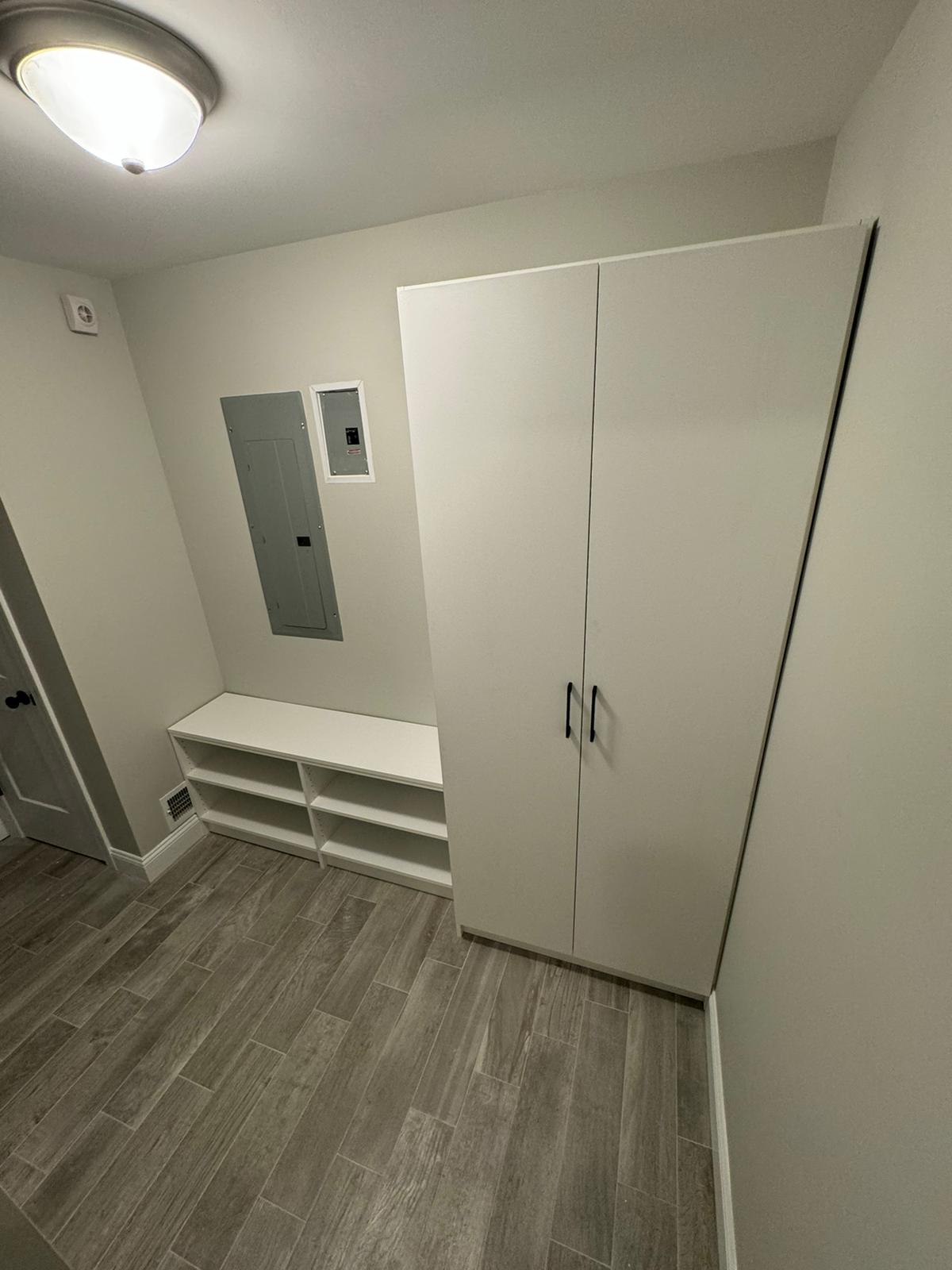 Walk-in pantry with comprehensive white shelving and organized food storage systems